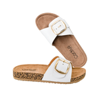 The Road Trip Buckle Slide Sandal by CORKY'S FOOTWEAR INC is a white slide sandal with a cork footbed, single wide strap, and large statement buckle, shown on a white background.