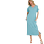 A woman smiles with hands in the pockets of the Zenana Round Neck Short Sleeve Midi T-Shirt Dress—a light blue cotton blend dress featuring side slits, a front pocket, and stylish comfort for any occasion.