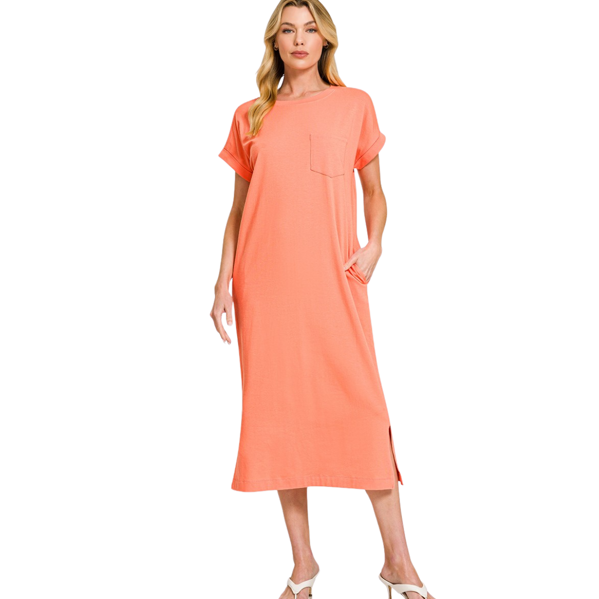 A woman models the Zenana Round Neck Short Sleeve Midi T-Shirt Dress, featuring a loose fit, chest pocket, and side slit, against a white background.