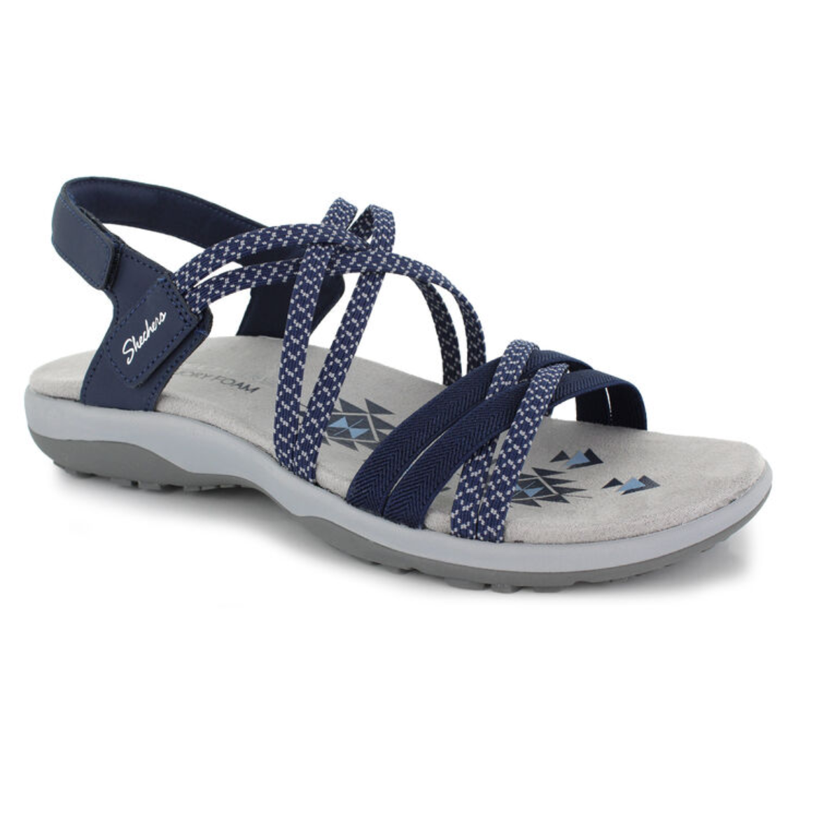 The Reggae Slim Perfect Take Navy Sandal by SKECHERS USA INC is a women’s sandal with crisscross straps, a cushioned gray memory foam footbed, geometric design, and a Velcro heel strap on a gray sole. Main image