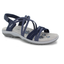 The Reggae Slim Perfect Take Navy Sandal by SKECHERS USA INC is a women’s sandal with crisscross straps, a cushioned gray memory foam footbed, geometric design, and a Velcro heel strap on a gray sole.