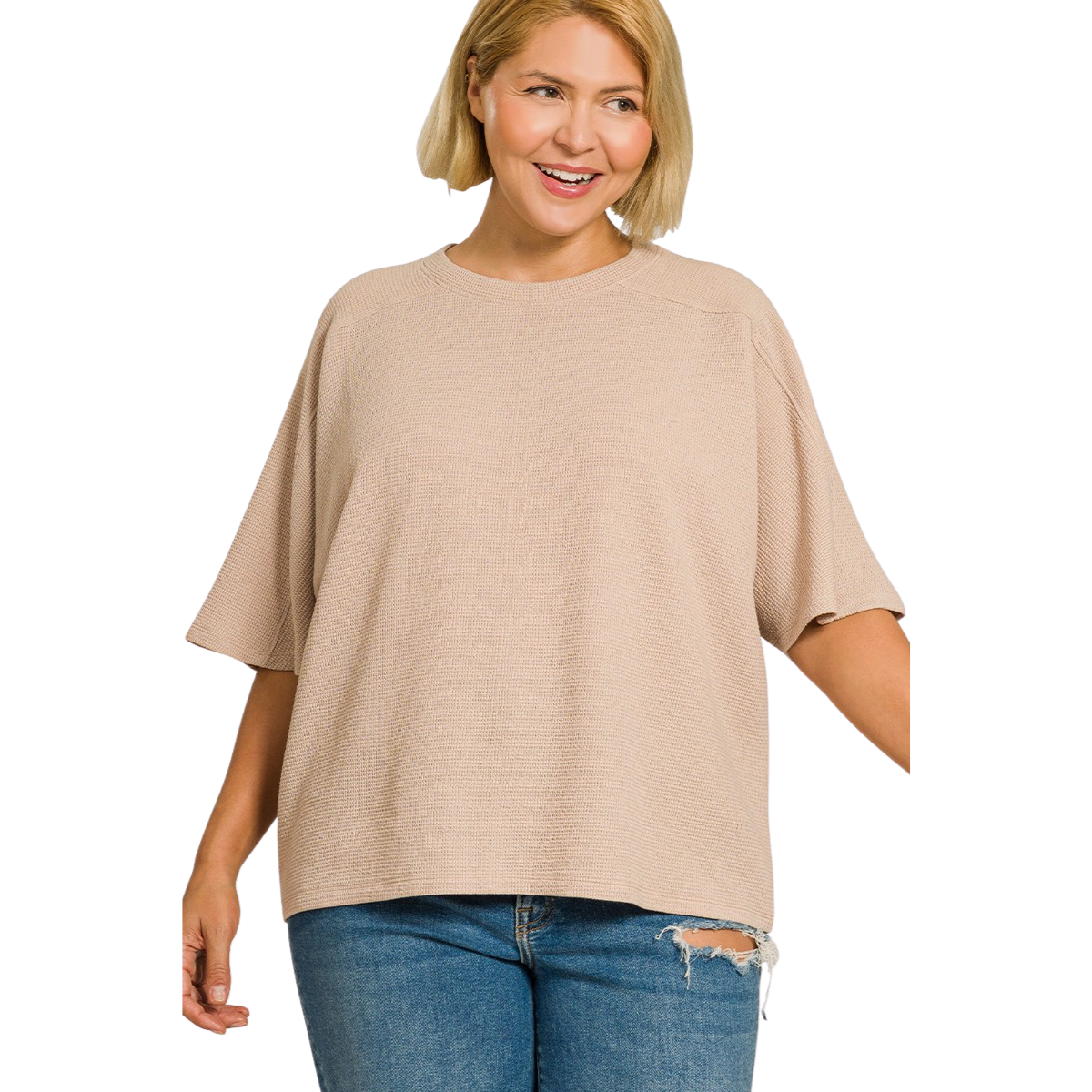 A woman smiles against a white background, wearing the Zenana Double Knit Short Sleeve Top in beige with ripped blue jeans—an effortless everyday look.