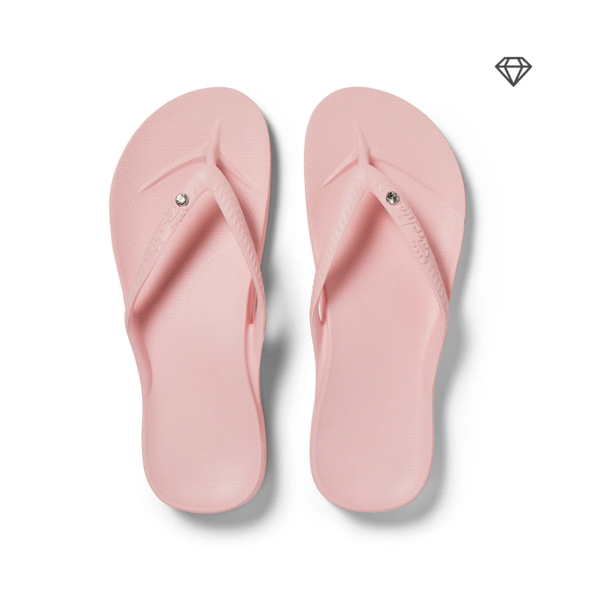 Archies Arch Support Flip Flops Crystal Pink by ARCHIES FOOTWEAR LLC feature light pink color, textured straps, arch support, and a small crystal detail on each strap, shown on a white background.