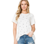 A person in the FASHION GO Star Print Tunic Top With Solid Sleeves and ripped blue jeans stands facing forward against a white background.