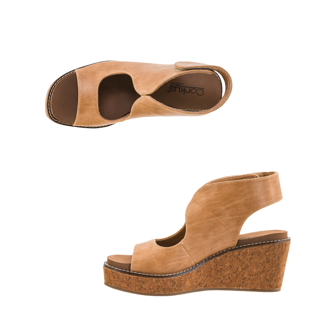 The Let’s Talk About It Wedge by CORKY’S FOOTWEAR INC showcases a tan cork platform sole, open toe, and adjustable ankle strap. Displayed from top and side angles on a white background, this sandal is crafted with a cushioned footbed for all-day comfort.