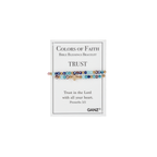 A multicolored beaded bracelet with a cross from Flipflops & Whatnots’ Blessing Bracelets - Assorted collection is displayed on a card reading “Colors of Faith Bible Blessings Bracelet: TRUST. Trust in the Lord with all your heart. Proverbs 3:5.” This inspirational jewelry piece serves as a daily reminder of trust and faith.