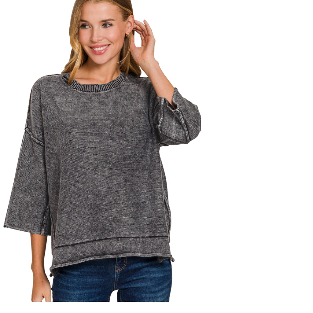 A charcoal gray Women’s Washed Cotton Boxy Sweater with 3/4 Sleeves, featuring a round neckline and boxy silhouette, worn with dark blue jeans.