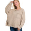 A woman poses against a white background wearing the Fashiongo Brushed Hacci Hi-Low Hem Top in ash mocha, featuring a loose fit, front pocket, and hi-low sweater design, paired with blue jeans.