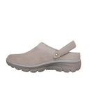 Light beige SKECHERS Easy Going Distinctive Charm Relaxed Fit suede clog with a back strap and textured rubber sole, featuring Air-Cooled Memory Foam for lasting comfort, shown from the side against a white background.
