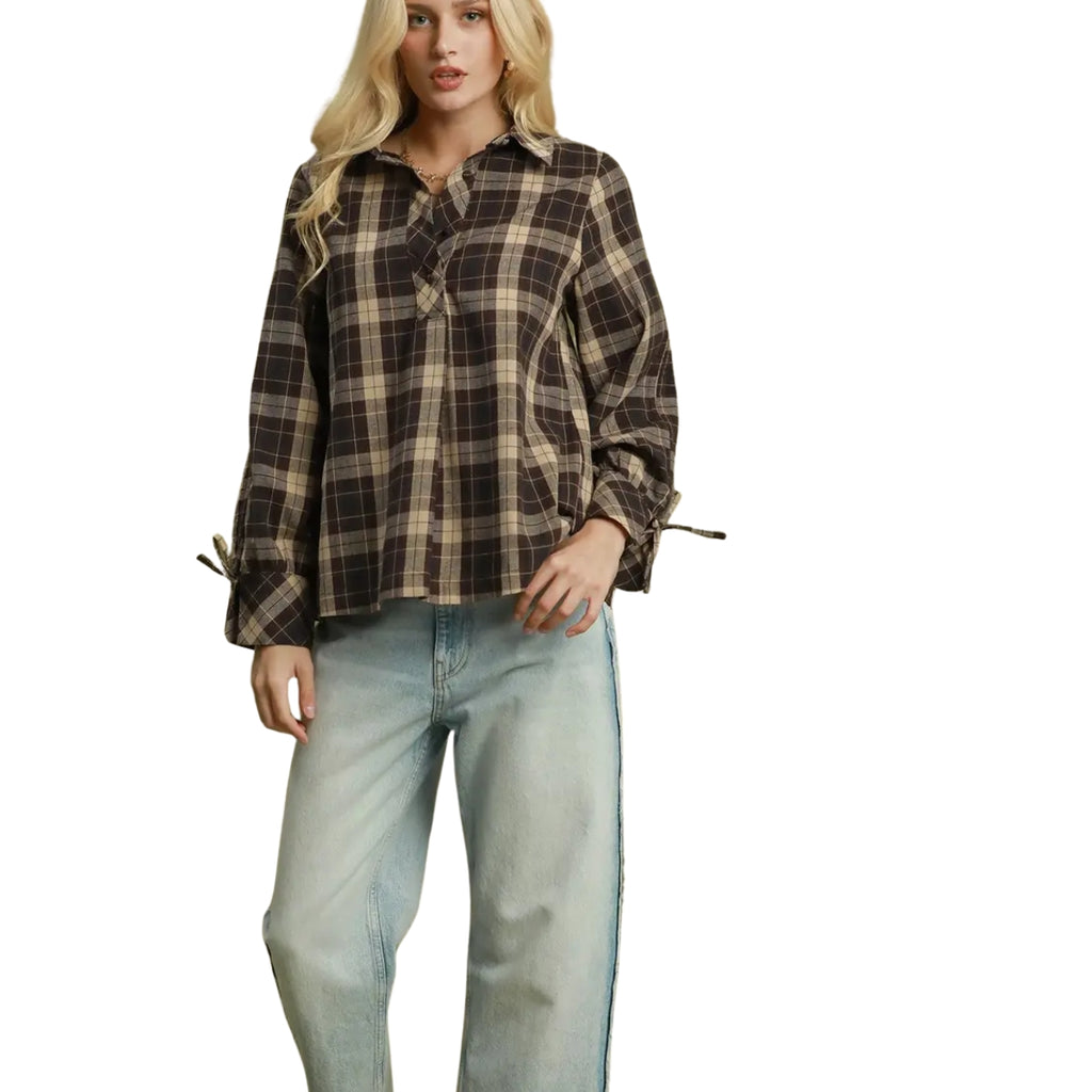 Woman wearing a brown and tan Plaid Tie Sleeve Button Up Blouse with light-wash jeans.