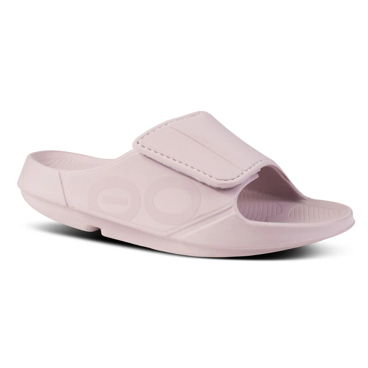 A single light pink Sport Flex Adjustable Slide in Stardust by OOFOS LL with an open toe, adjustable strap, and textured footbed featuring OOfoam technology for ultimate comfort, set against a plain white background. Perfect for recovery after a long day.