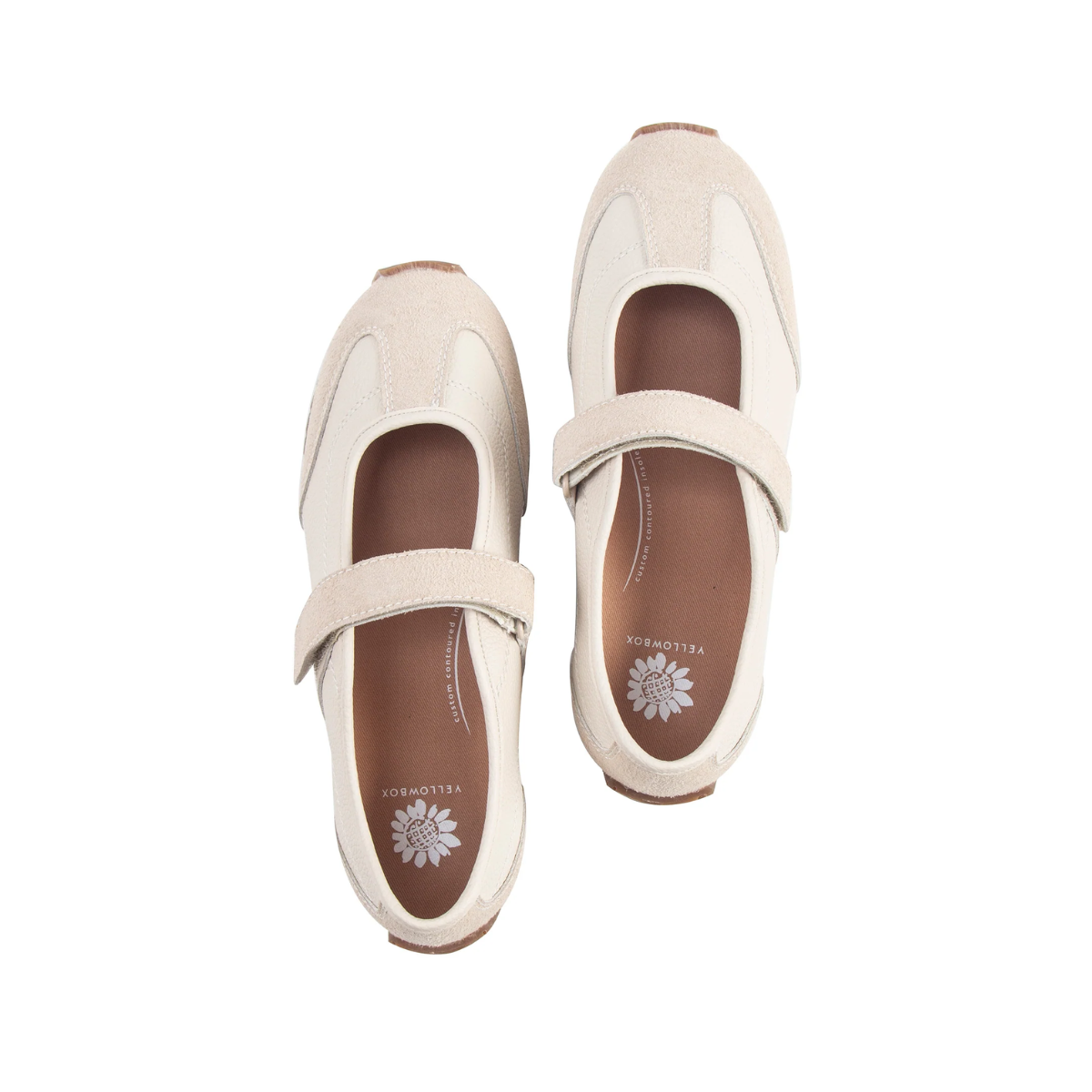 The Yellow Box Alina MaryJane Sneaker, shown from above on a white background, features a cream-colored design with beige suede accents, brown soles, and a single top strap. This retro-runner silhouette offers cushioned comfort in every step.