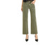 A woman wearing Fashiongo Tummy Control Mid Rise Ankle Straight Raw Hew Pants in olive, a black top, and black heels stands confidently with one hand in her pocket.