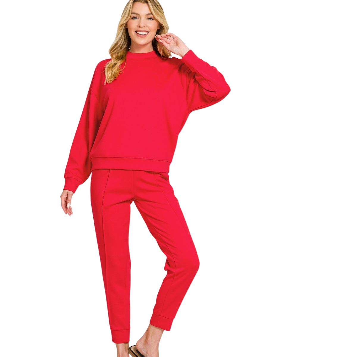 A woman smiles, wearing the FASHION GO Scuba Fabric Mock Neck Pullover Jogger Set—a matching bright pink long-sleeve sweatshirt and relaxed waist pants—with one hand raised near her hair.