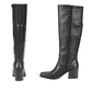 The Tammey Tall Boot in Black by Baretraps is shown from the back and side, featuring knee-high heels and a faux leather finish against a white background.