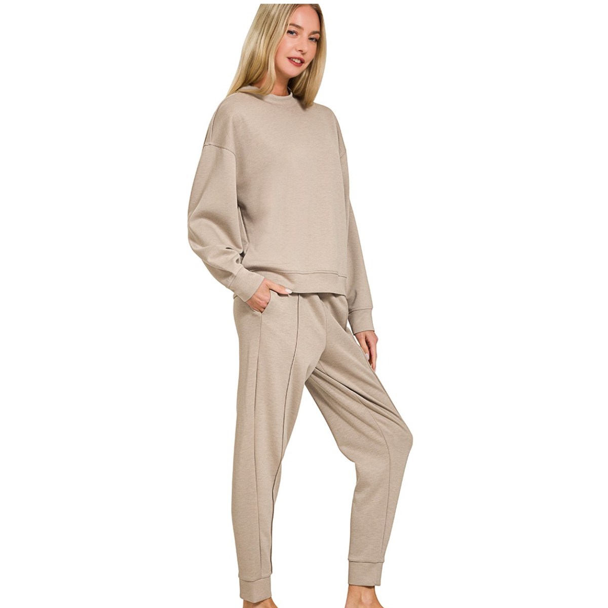 A woman models the FASHION GO Scuba Fabric Mock Neck Pullover Jogger Set in beige, featuring a long-sleeve top and relaxed-fit pants with pockets, creating a modern, effortless style against a white background.