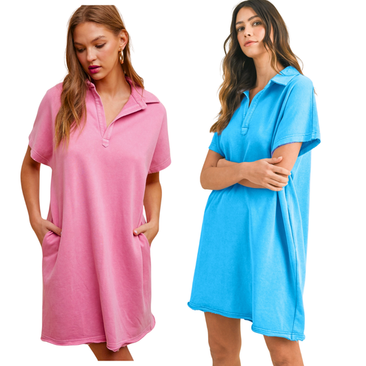 Two women wear FASHION GO’s Mineral Washed French Terry Dress, featuring short sleeves, a collared neckline, and a loose fit in pink and blue. Both pose with hands in pockets, showcasing the dress's casual comfort.