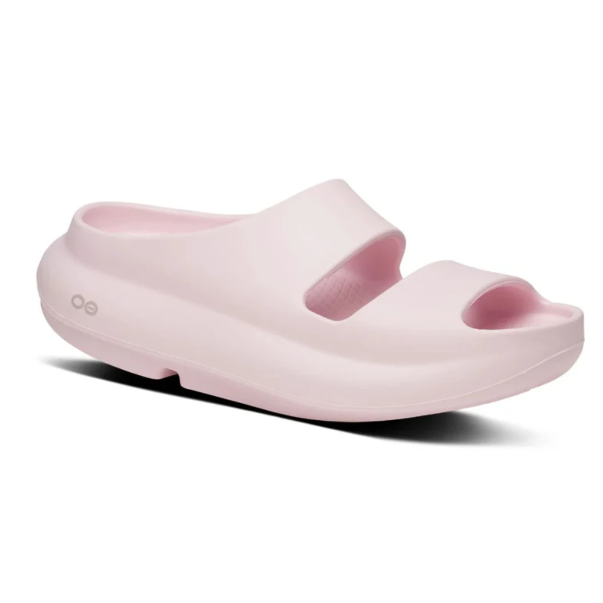 The Oofos OOyea Sandal Primrose by OOFOS LLC is a light pink women's slip-on recovery sandal featuring two wide upper straps, an open toe, and a thick OOfoam technology sole. Main image