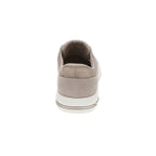 A rear view of the SKECHERS USA INC Arch Fit Cuddle Steps Slip Ins sneaker in beige highlights its heel, white sole accented with a brown stripe, and quilted upper pattern. Featuring Arch Fit support, this style ensures enhanced comfort for everyday wear.
