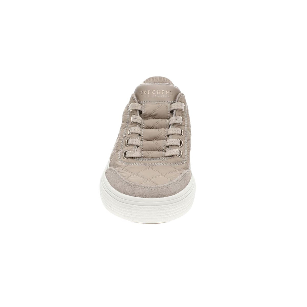 A front view of the SKECHERS USA INC Arch Fit Cuddle Steps Slip Ins in beige shows quilted stitching and a white sole against a plain white background, featuring Cozy Fit comfort and supportive Arch Fit support.