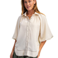 A woman wears the FASHION GO Satin Balloon Sleeve Button Down Blouse with wavy hem and stitch detail, standing against a white background.
