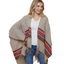 A woman smiles in the FASHION GO Striped Wrap—an acrylic shawl with red, yellow, and brown stripes—styled over a white shirt and blue jeans against a white background.