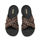 The SKECHERS Go Walk Flex Sandals in Leopard feature crisscross leopard print fabric straps and a comfortable slip-on design, shown from above on a white background. Bold style meets all-day comfort in this standout pair.
