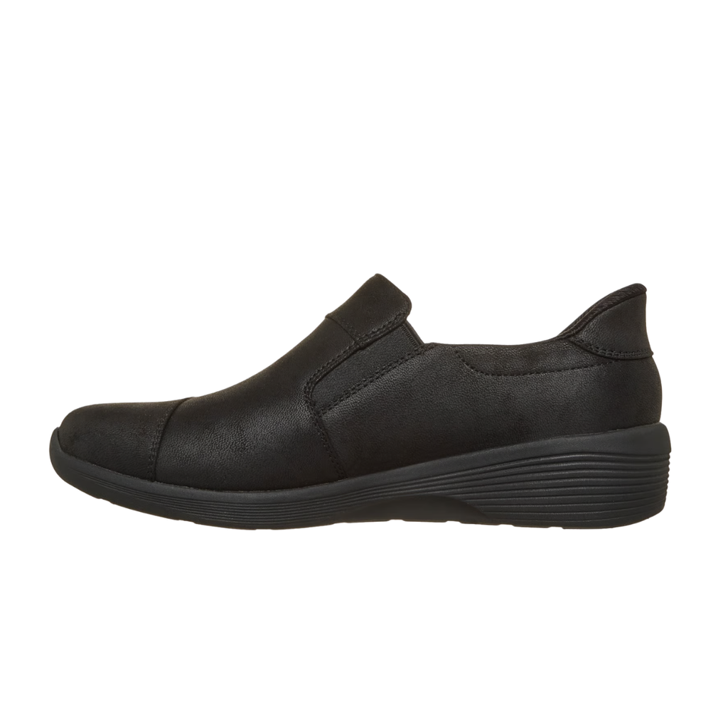 The SKECHERS Silvana Black Slip-Ins Sneaker features a hands-free design with a low wedge heel, rounded toe, and subtle stitching details, presented in a left side profile view. Enhanced with Air-Cooled Memory Foam, it offers superior cushioning and all-day comfort.