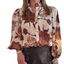 A woman wears the FASHION GO Floral Print Button Down Poet Sleeve Shirt in cream, styled with high-waisted dark pants for an elegant fall outfit.