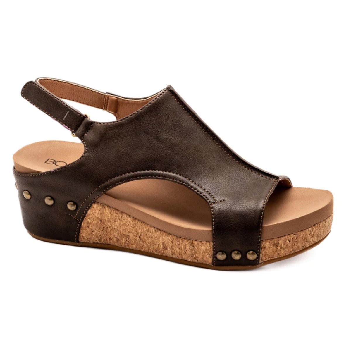 The Volta II Low Wedge in Chocolate by CORKY'S FOOTWEAR INC features a cork sole, studded details, slingback strap, and side cut-outs—ideal for all-day comfort and style.