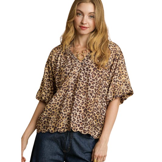 A woman wears the Umgee Bubble Sleeve Tan Leopard Print Top with dark jeans against a white background—an effortless addition to any fall wardrobe.