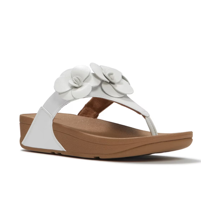 The Lulu Flower Flip Flop by FIT FLOPS from FITFLOP USA LLC is a white wedge sandal with two flower appliqués on the strap, a tan sole, and supportive arch comfort.