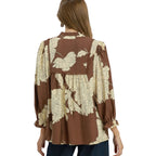 A woman with long hair is shown from the back wearing the Umgee Brown and Ivory Floral Peasant Blouse, which features balloon long sleeves and a cream floral pattern.