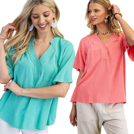 Two women wear FASHION GO Washed Linen V-neck Tops—one turquoise, one coral—against a white background.