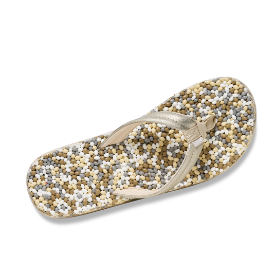 The Lole Brands Sanuk Bubblecush Flip Flops feature a beige color, cushioned footbed, and a textured sole with small multicolored beads in white, tan, brown, and gray for comfort and style.