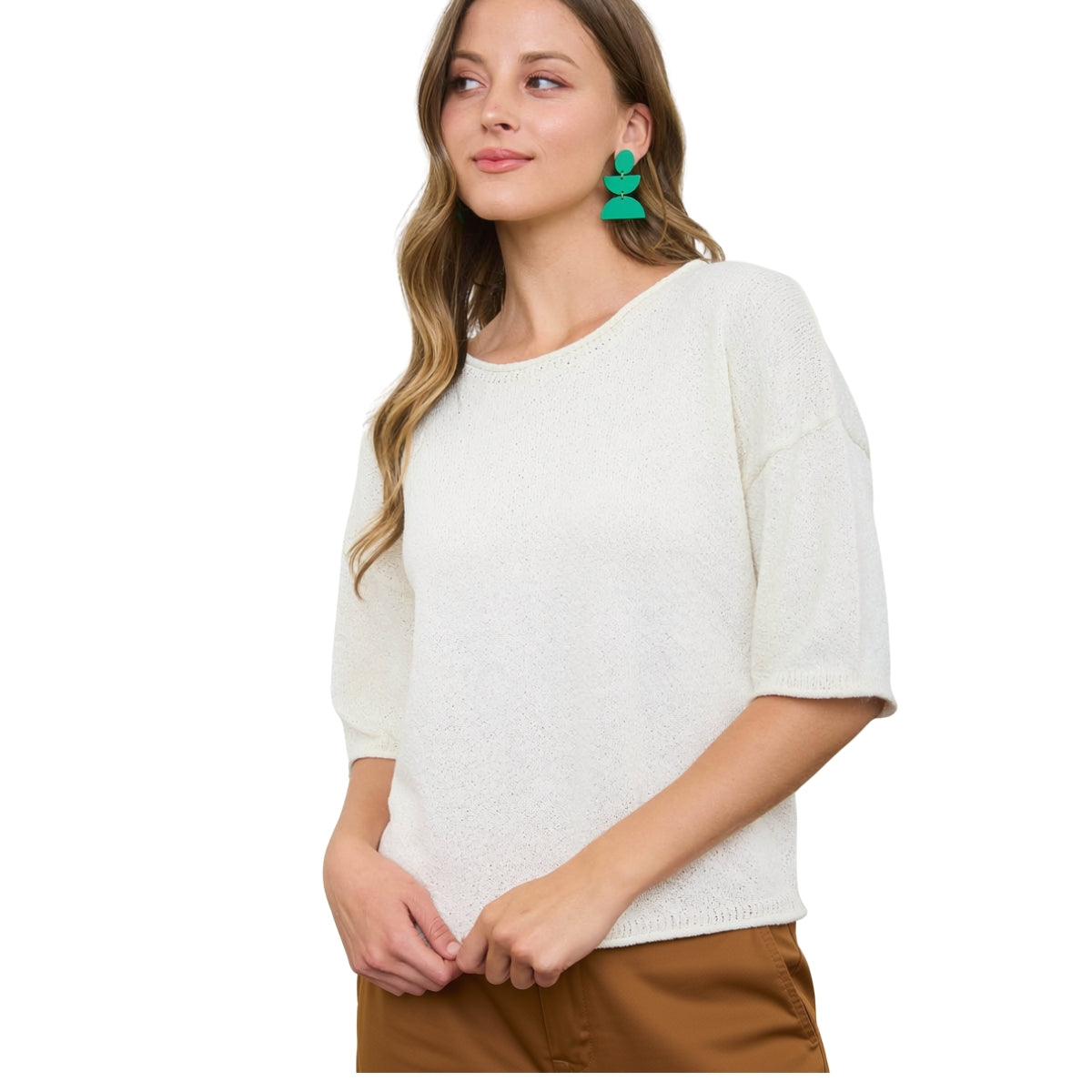 A woman wears the Raw Edge Boxy Short Sleeve Sweater by FASHION GO, paired with brown pants and green statement earrings, posed against a white background. Main image