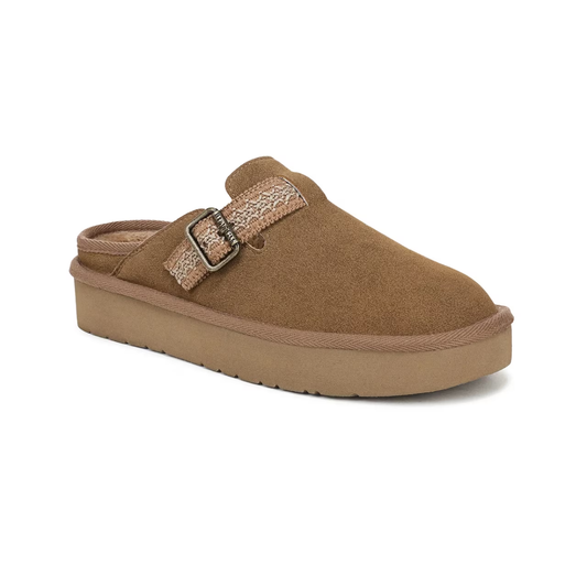 The Blowfish Malibu Monday Clog by CALERES INC is a brown tan faux suede slip-on with a tan buckle strap and thick rubber sole, pictured at a three-quarter angle on a white background.