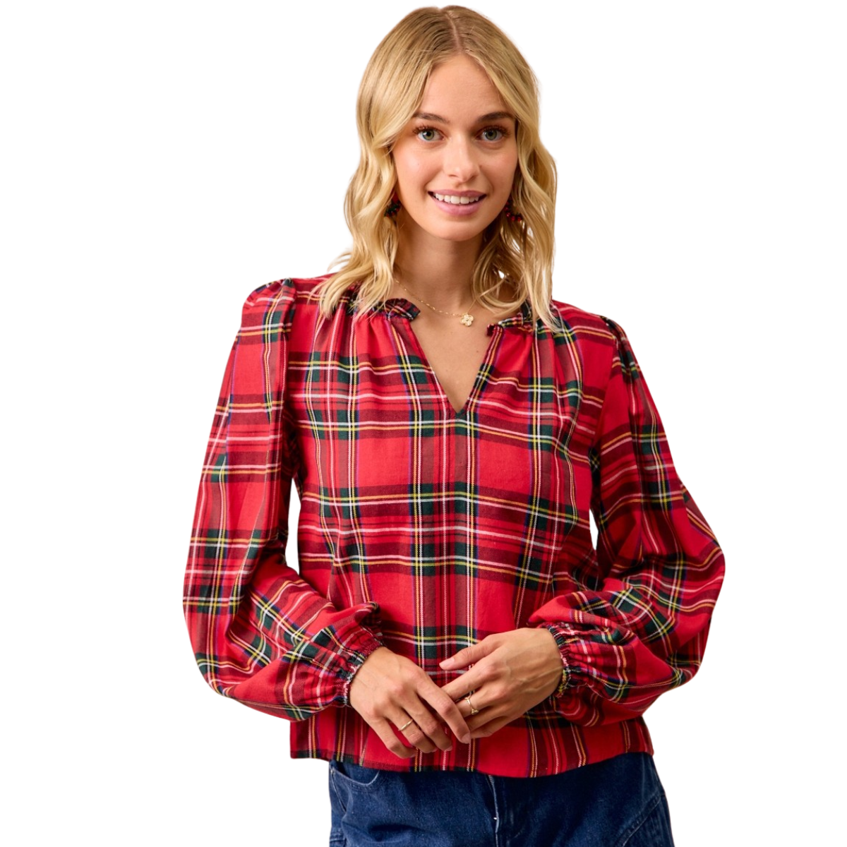 A woman smiles at the camera wearing FASHION GO's Christmas Plaid Balloon Sleeve Ruffled V-Neck Top with blue jeans, standing against a white background.