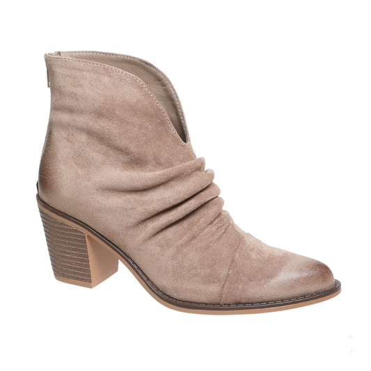 The Pierre Dumas Kacee-5 in Taupe by OLEM SHOE CORP is a suede ankle boot with a stacked block heel and ruched side detail, ideal for elevating your style.