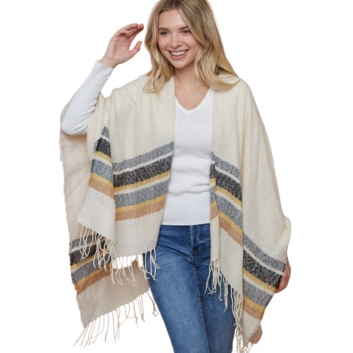 A woman stands and smiles, wearing the FASHION GO Striped Wrap with cream, gray, and mustard stripes and fringe, draped over a white ribbed sweater and blue jeans.