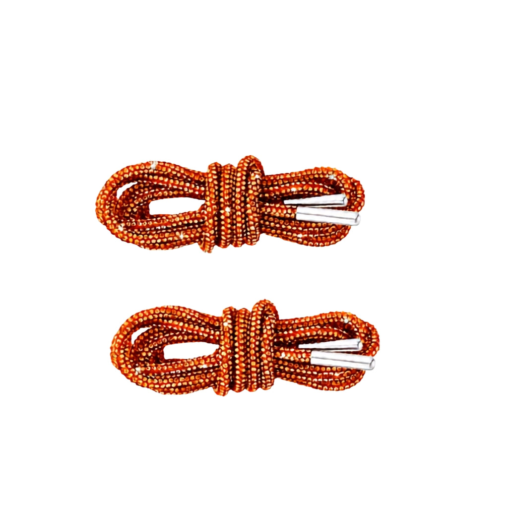 Two coiled Orange Rhinestone Shoelaces by AMAZON.COM, featuring black decorative accents and white aglets, placed parallel to each other on a white background.