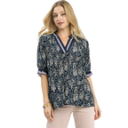 A woman wearing the Umgee Spring Burst Top in Navy Floral with half sleeves and light-colored pants stands against a white background.
