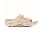 The SKECHERS Go Walk Arch Fit Chloe sandal in beige features a textured upper, two adjustable buckle straps, and a thick contoured sole with arch support—shown in profile against a white background.