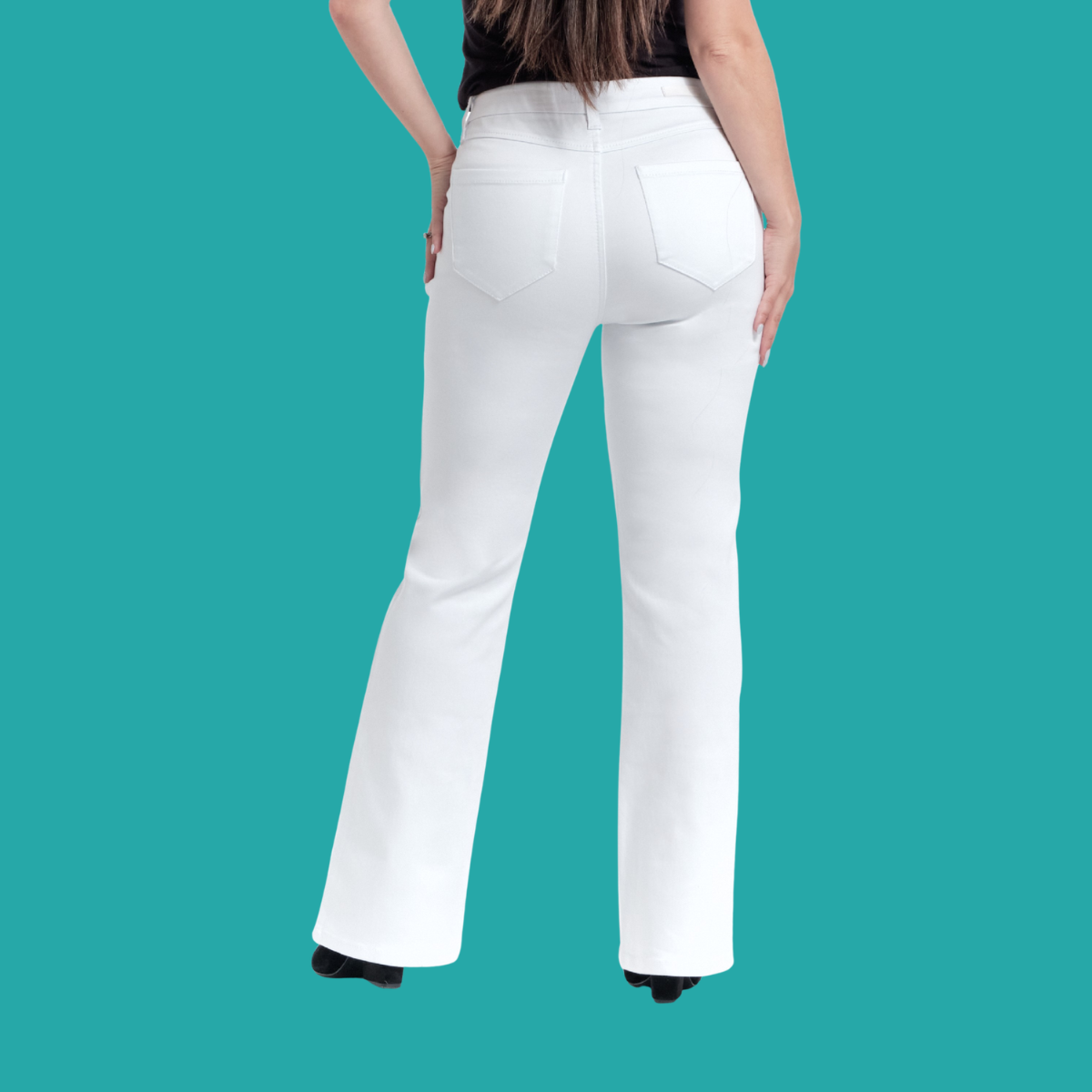 A woman, seen from behind, wears FASHION GO's 30" inseam Better Butter White Jeans and a black top against a solid teal background.