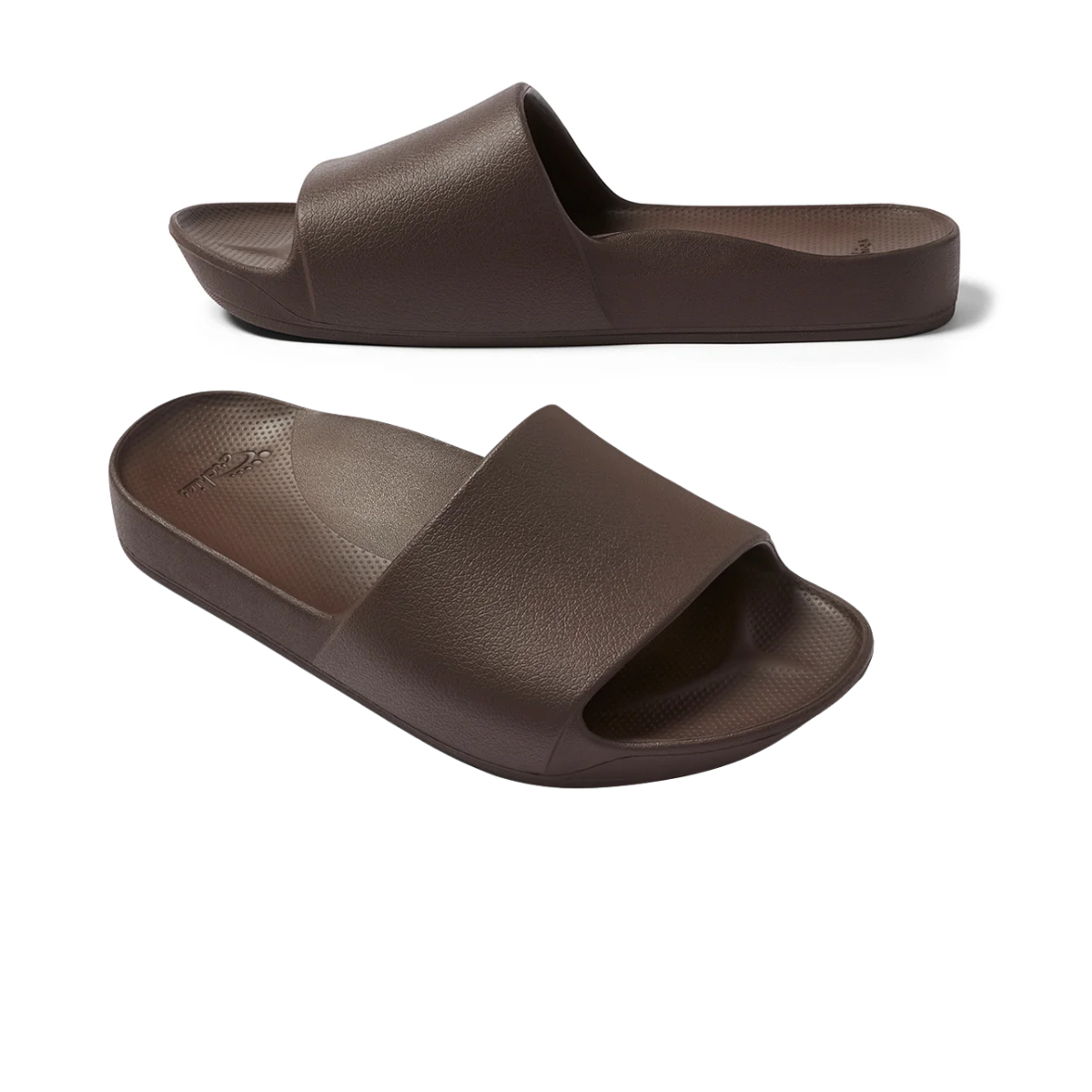 The Archies Slide Sandal in Brown by ARCHIES FOOTWEAR LLC features a single wide strap, textured footbed, and arch support, shown from side and three-quarter angles on a white background. Main image
