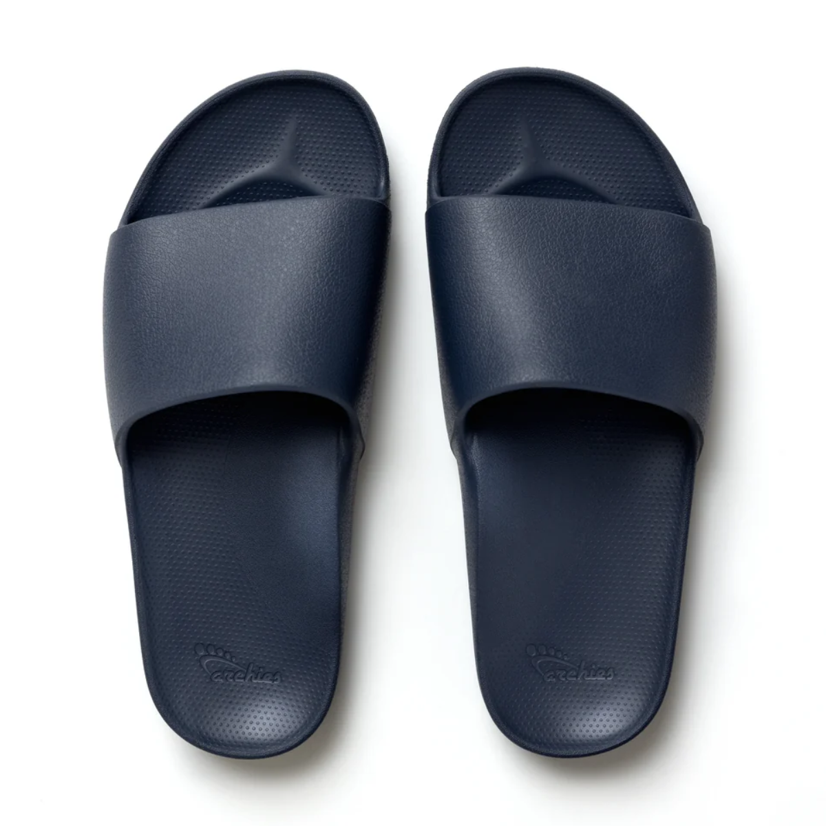 The Archies Slide Sandal in Navy by ARCHIES FOOTWEAR LLC features a wide strap and textured footbed, shown from above against a white background. Main image