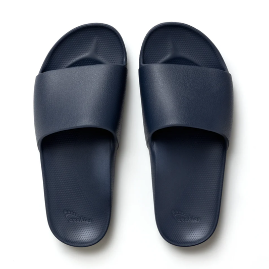 The Archies Slide Sandal in Navy by ARCHIES FOOTWEAR LLC features a wide strap and textured footbed, shown from above against a white background.