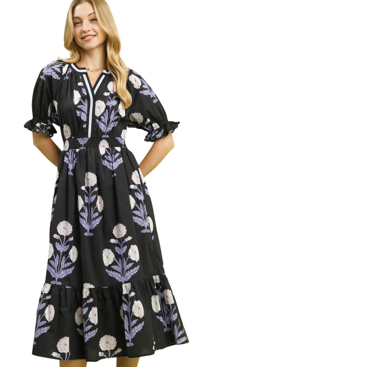Woman in the Umgee Floral Smocked Midi Dress Blue and Black, a mid-length dress with puff sleeves and smocked waistband, featuring a blue and black floral pattern, standing against a white background. Main image