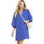 A woman wearing the Umgee Textured Pocket Mini Dress in ocean blue with three-quarter sleeves and a scalloped hem, carrying a small white shoulder bag.