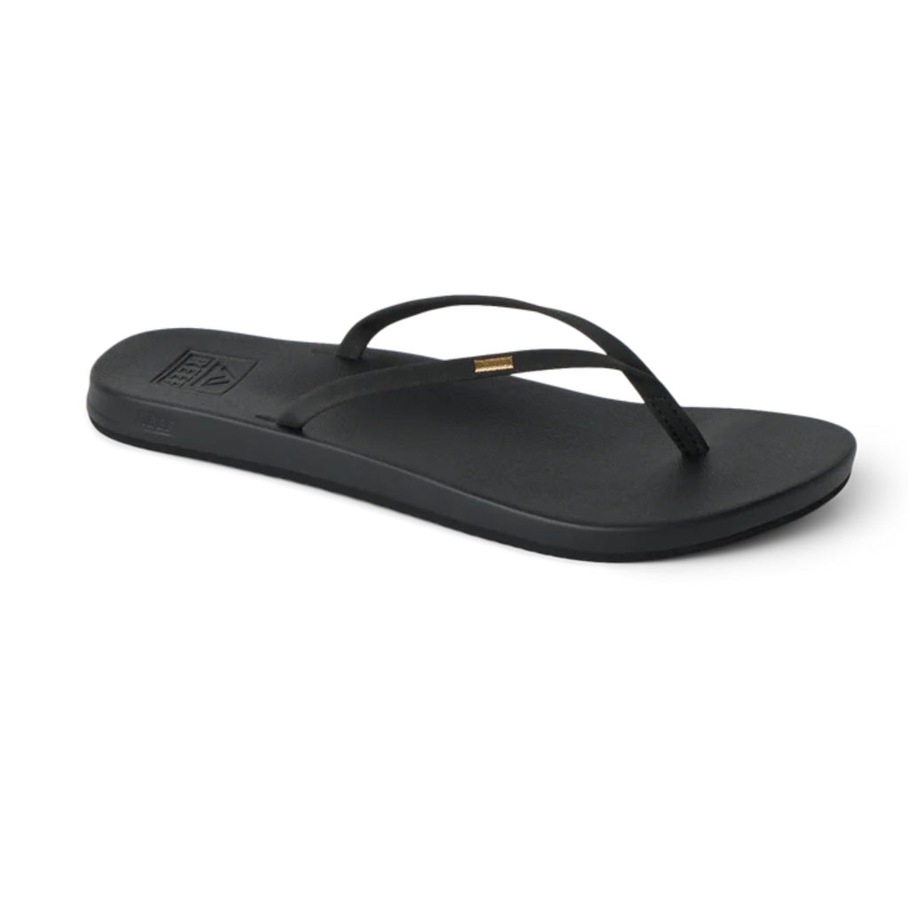 The REEF Cushion Slim Flip Flop in Black is displayed on a plain white background, featuring a simple thong strap design and cushioned footbed, making it an ideal choice for summer sandal enthusiasts seeking comfort.